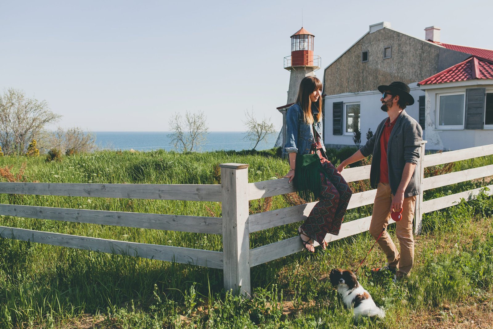 A couple relaxing near a home in a farmland